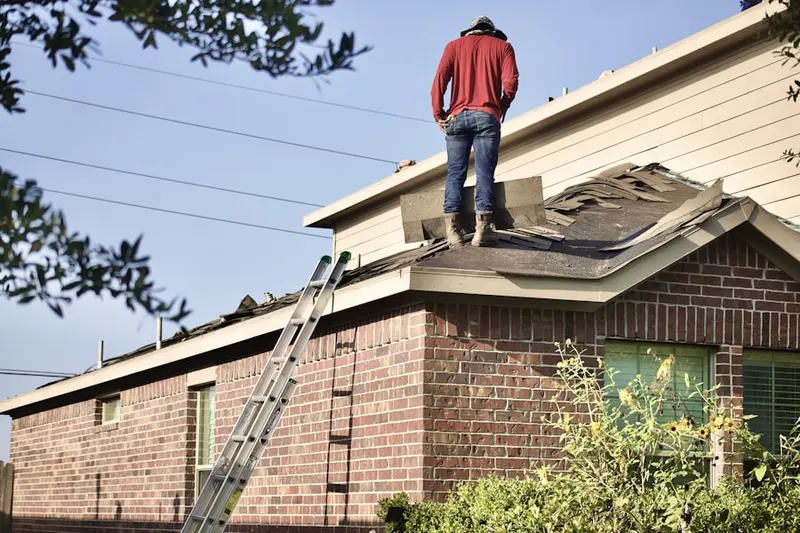 Professional roofer working on a residential roof in Guntersville